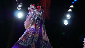 A Main Character is performing on the stage. There are no more than 30 actors and actresses able to perform as main characters in Cantonese opera in Hong Kong.